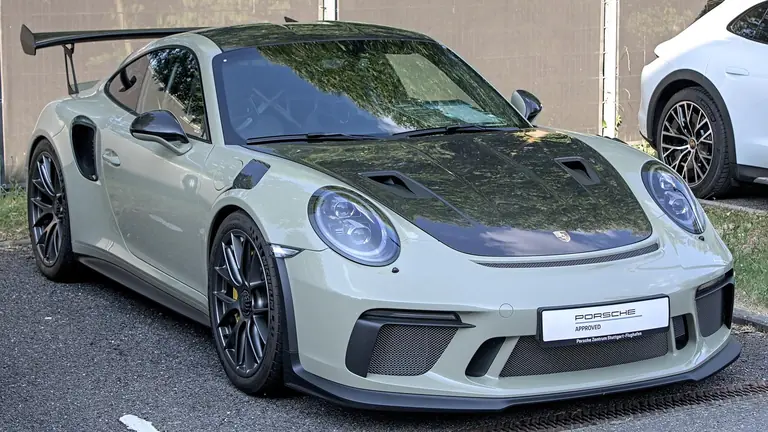 Pale grey-green Porsche 991.2 GT3 RS with the Weissach Package and an exposed carbon hood, front three-quarter view